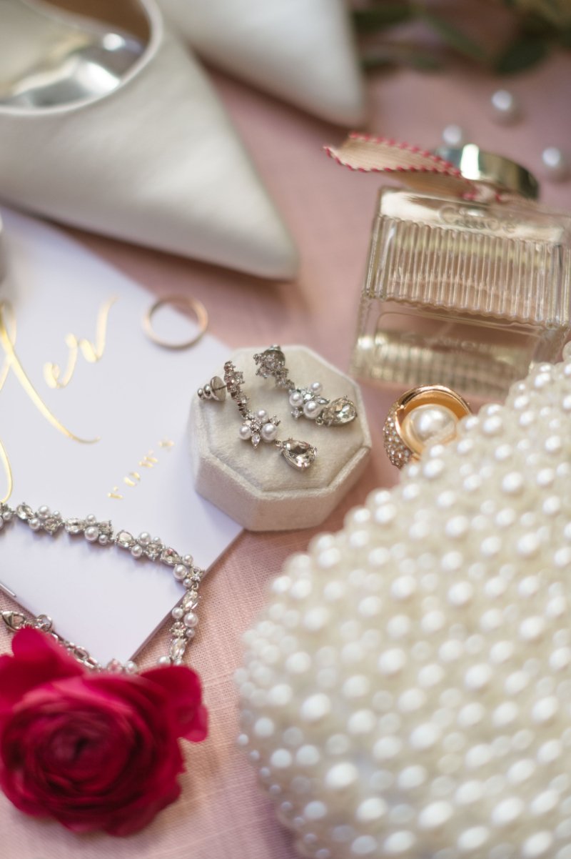 Soft bridal details with rings, earrings, and perfume, showing how to plan a small wedding beautifully