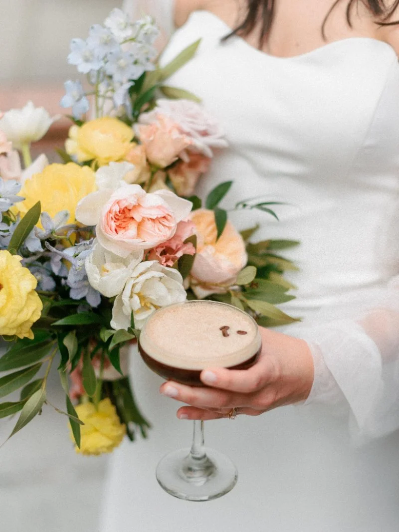 Soft bridal bouquet with pastel blooms and espresso martini, capturing an elegant, relaxed wedding moment