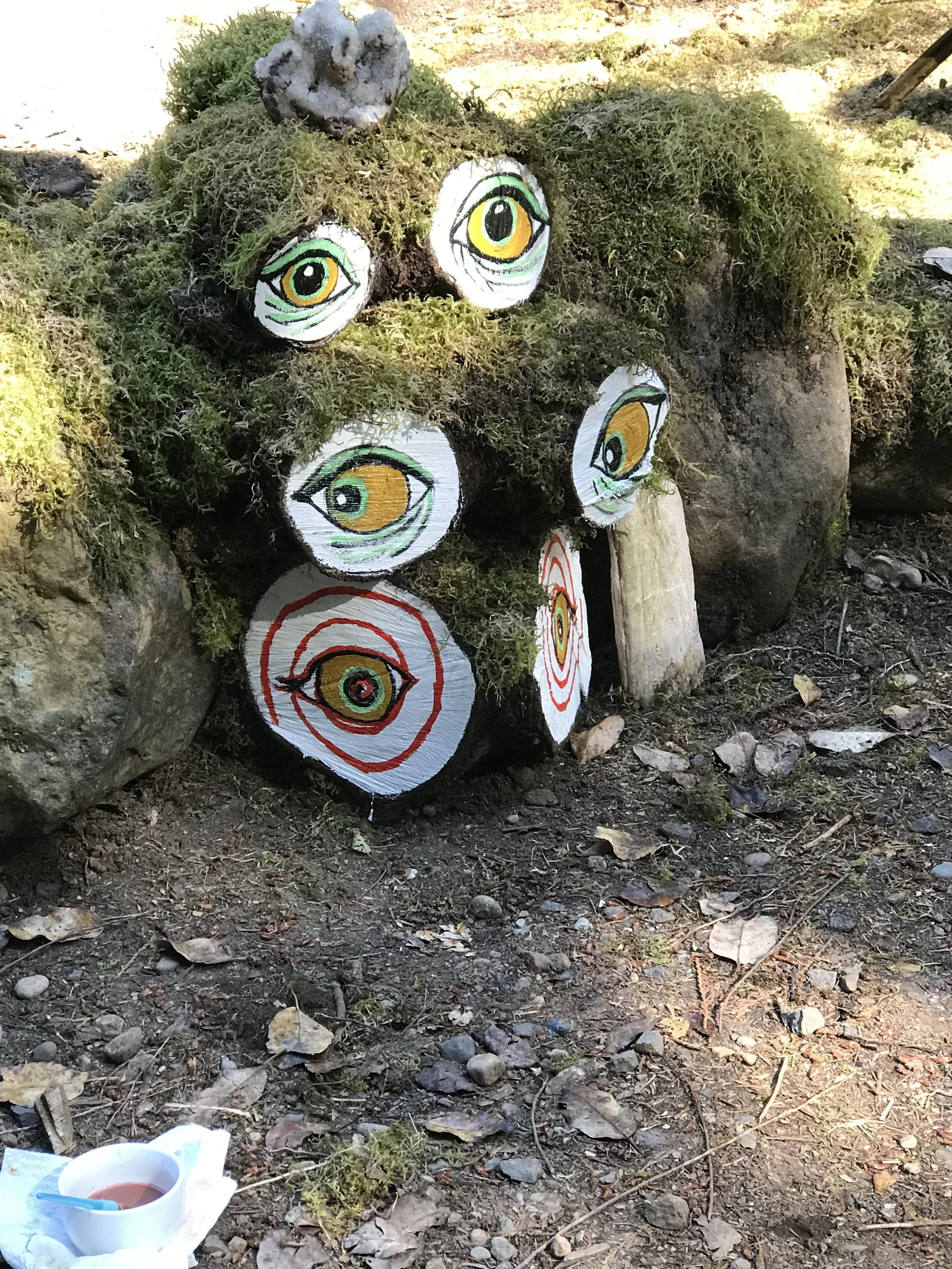 the 3 crazy ladies :) painted eyes on log stumps
