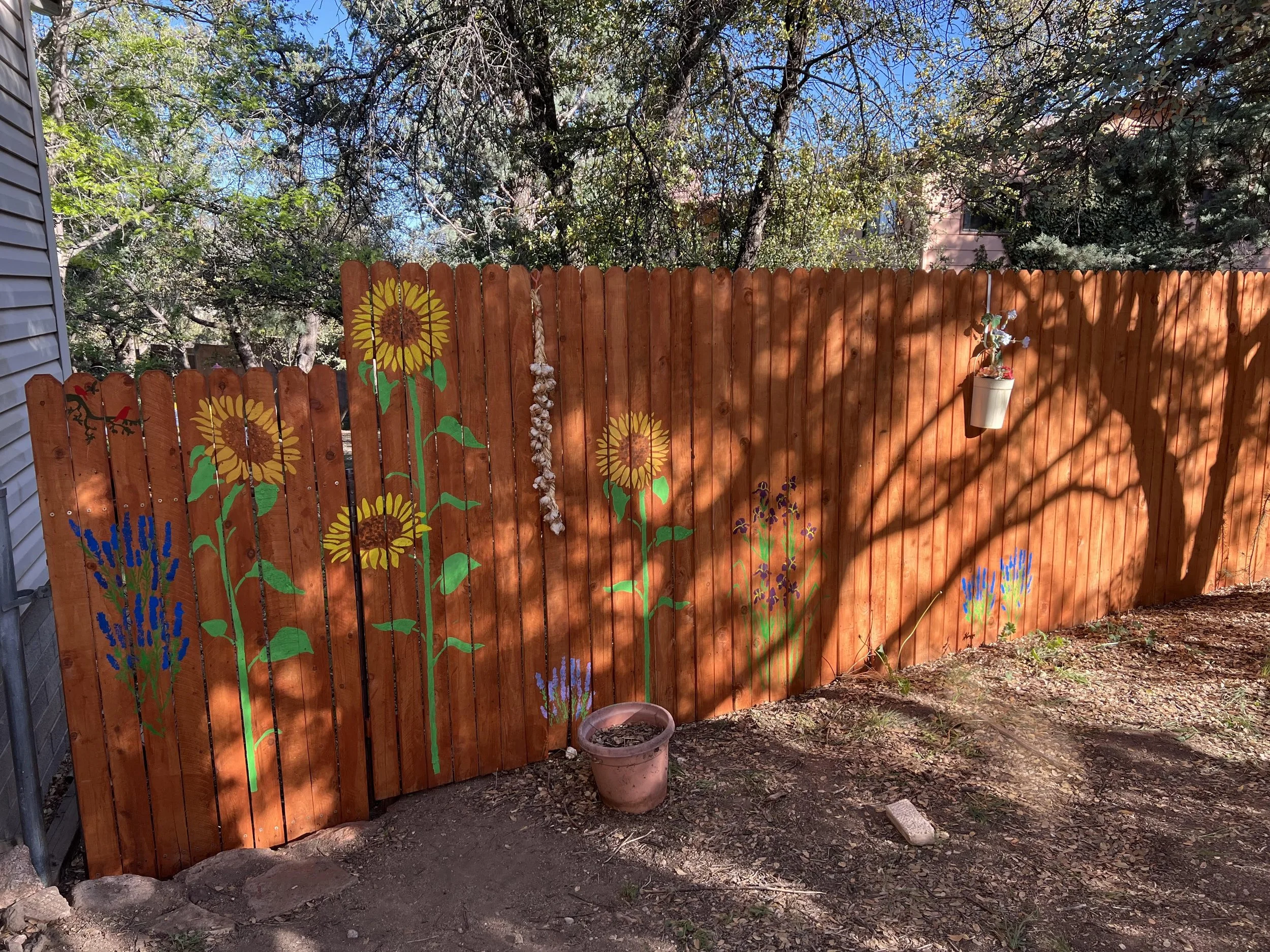 stained fence with painted flowers