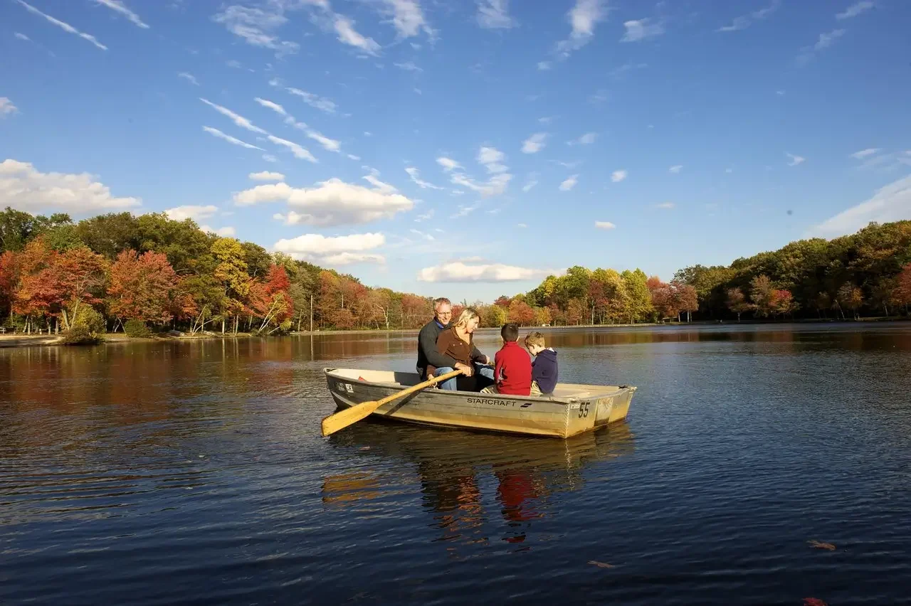 Family enjoying a rowboat on the private lake at Mountain Springs Lake Resort