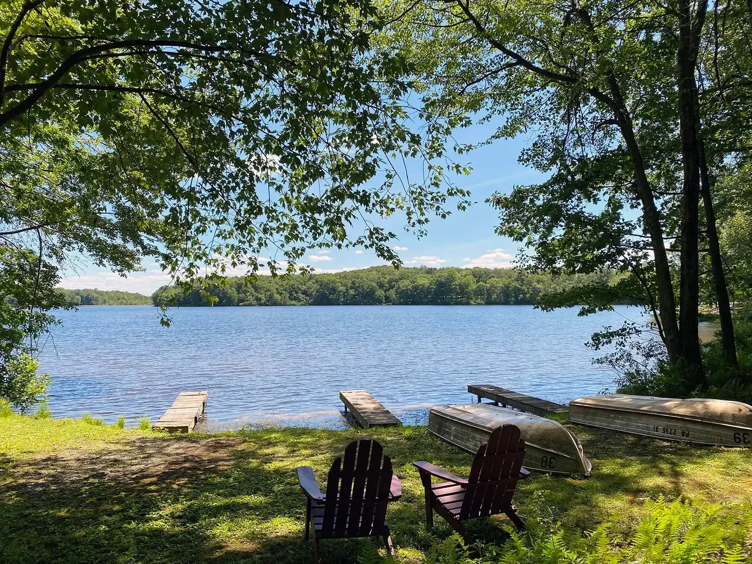 Lakefront Adirondack chairs and rowboats at Mountain Springs Lake Resort