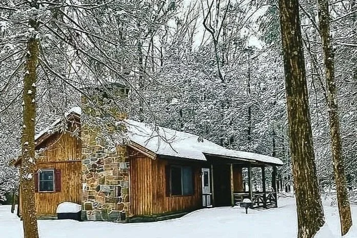 Snow-covered Pocono cabin at Mountain Springs Lake Resort during winter