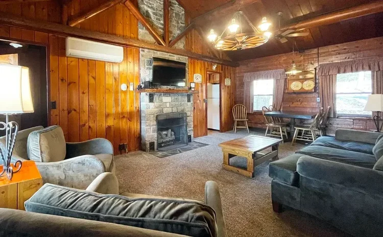 Spacious family cabin living room with a stone fireplace