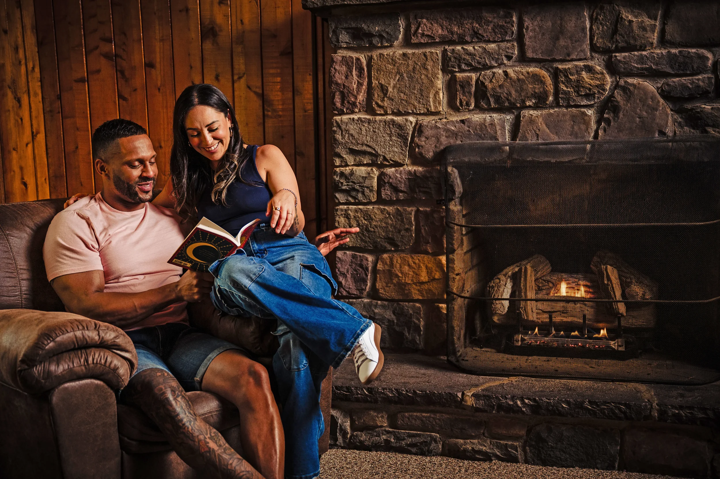 Couple relaxing by a fireplace in a cozy cabin at Mountain Springs Lake Resort