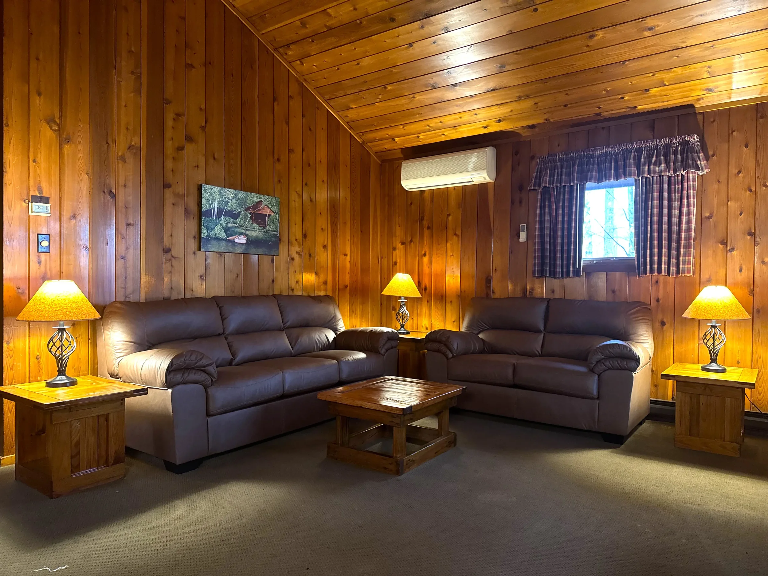 Cozy wood-finished cabin living room at Mountain Springs Lake Resort