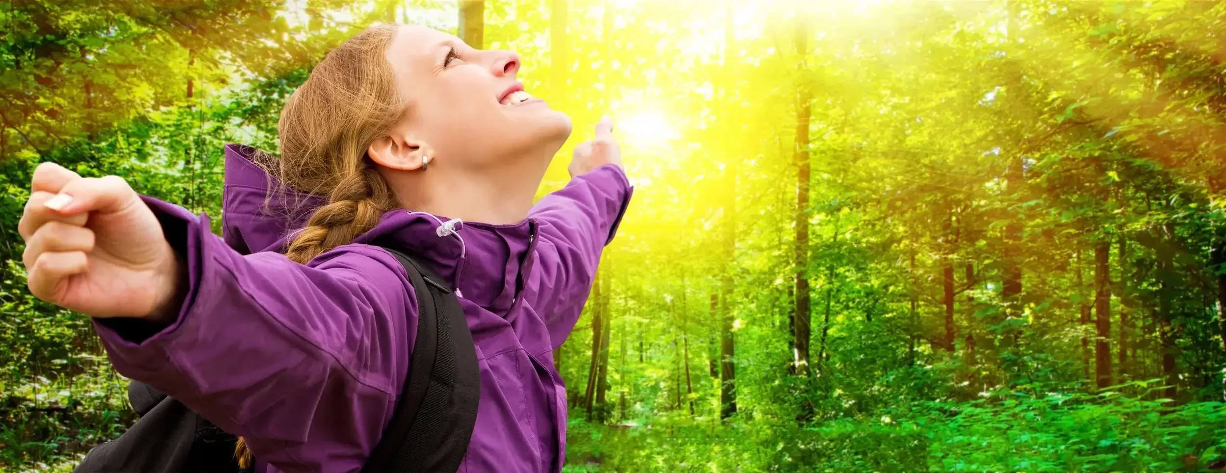 Hiker enjoying a sunny spring walk through the woods