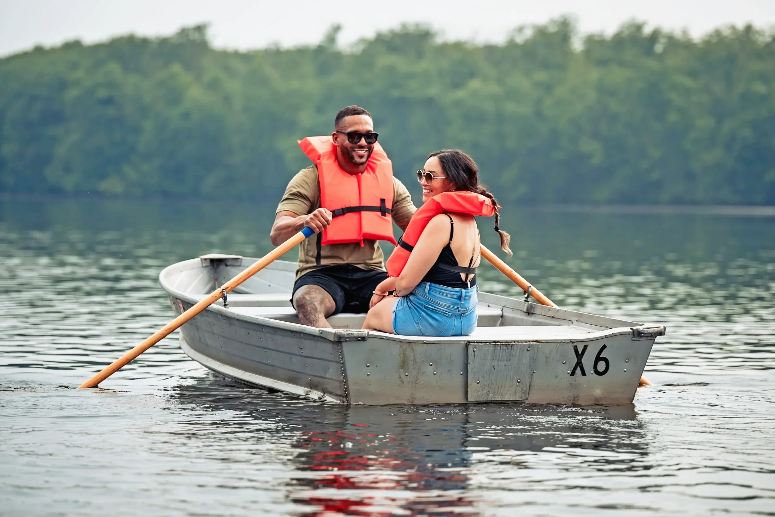 Couple enjoying a rowboat ride on the lake at Mountain Springs Lake Resort