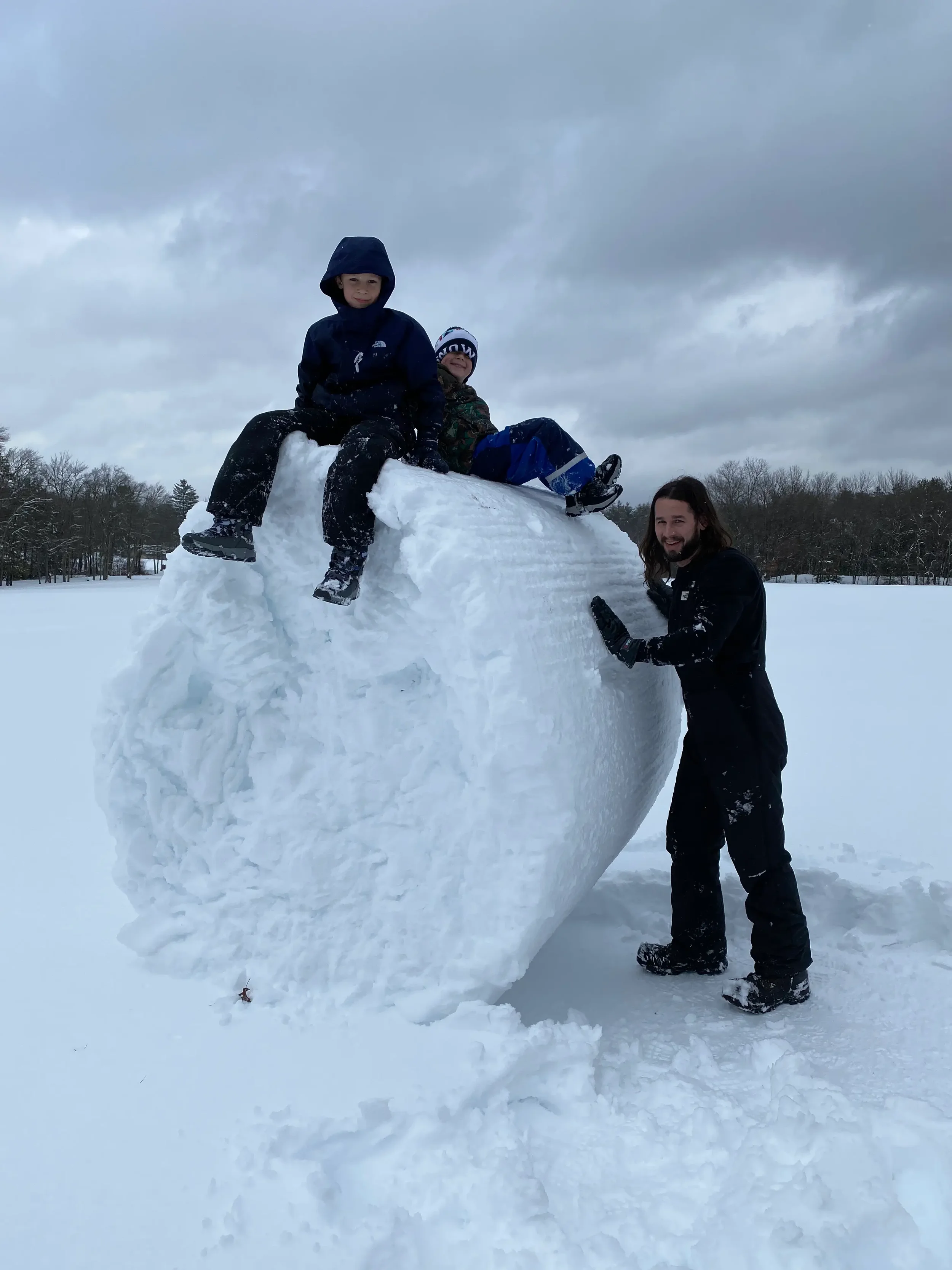 Family enjoying winter fun in the snow at Mountain Springs Lake Resort in the Pocono Mountains