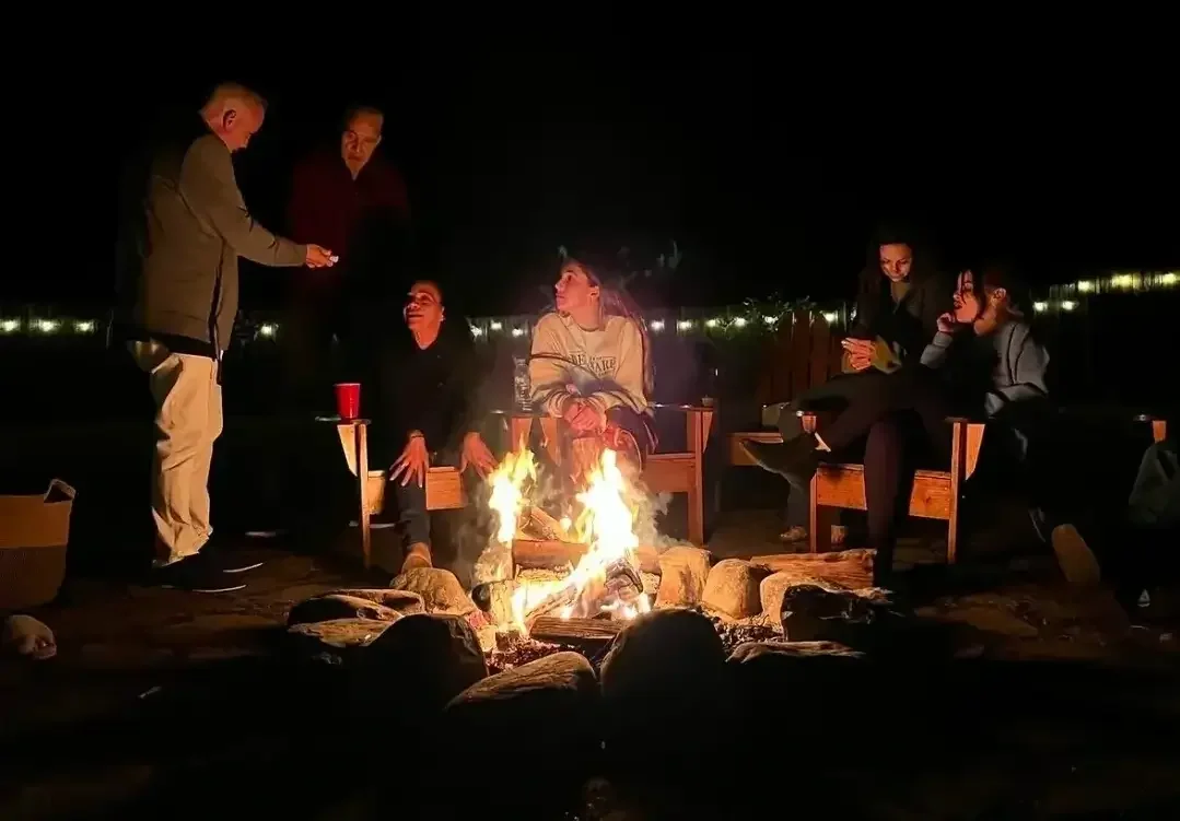 Guests enjoying a peaceful lakeside firepit at Mountain Springs Lake Resort