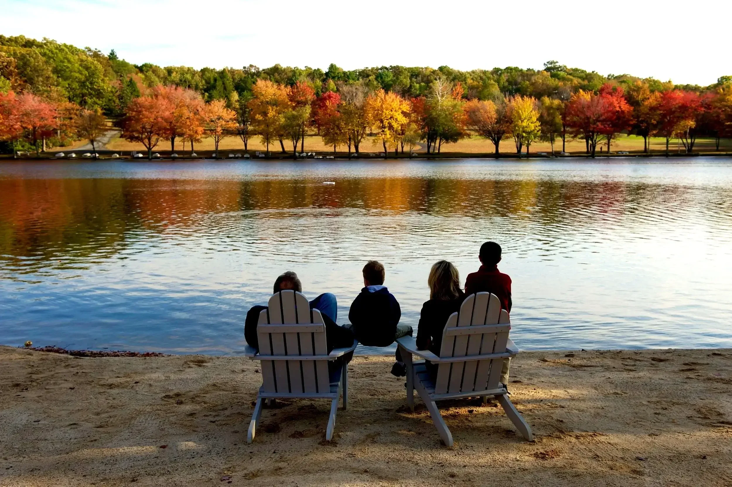 Family relaxing by the lake at Mountain Springs Lake Resort