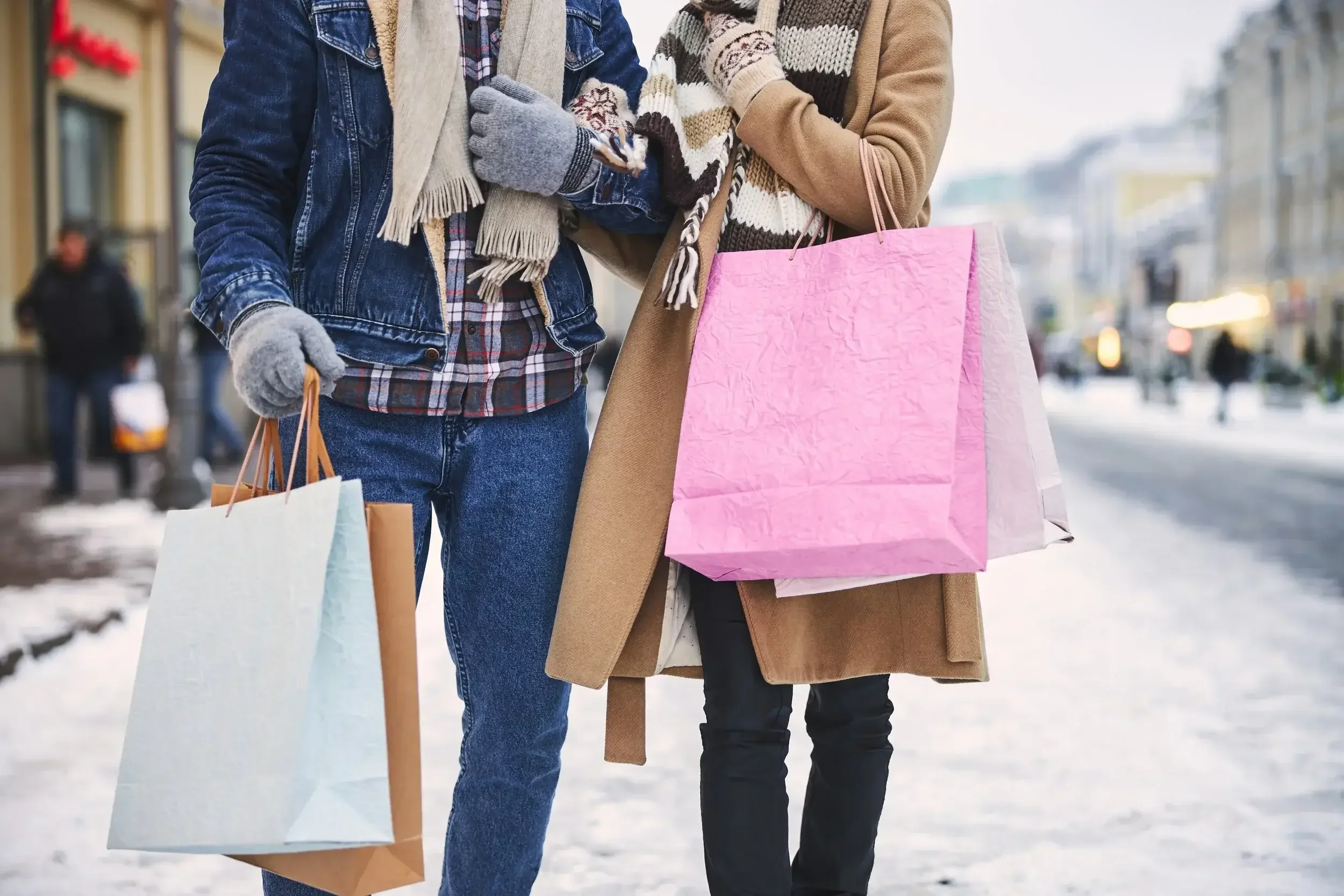 Couple carrying shopping bags during a winter Pocono getaway