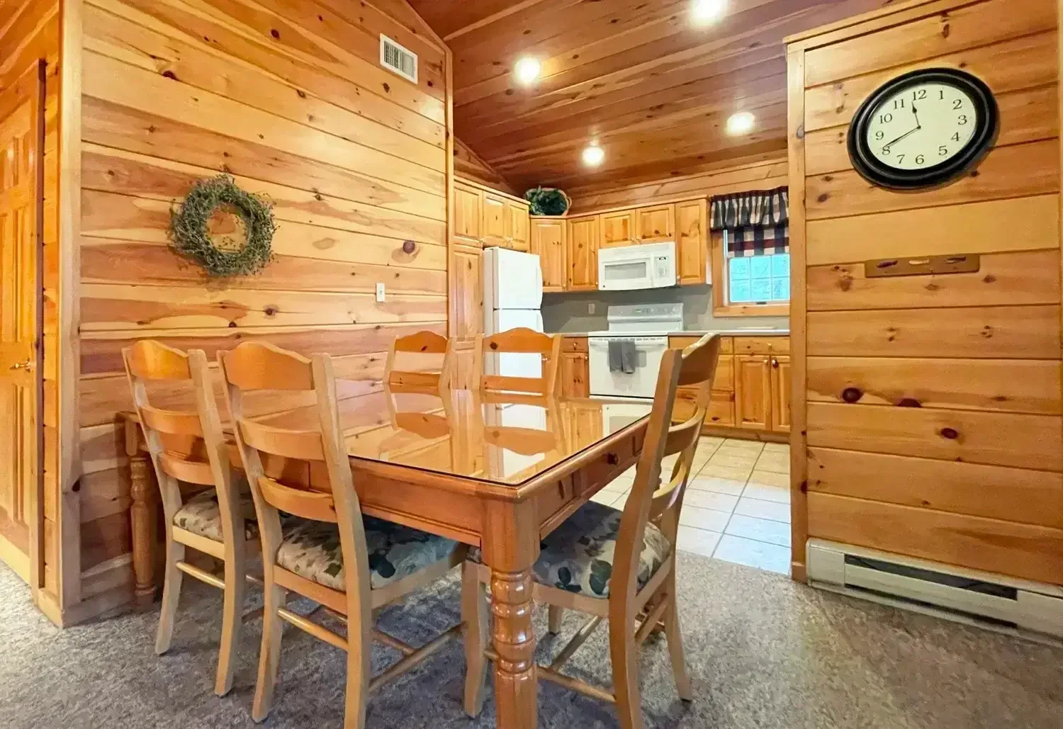 Cozy cabin kitchen and dining area with warm wood interiors at Mountain Springs Lake Resort.