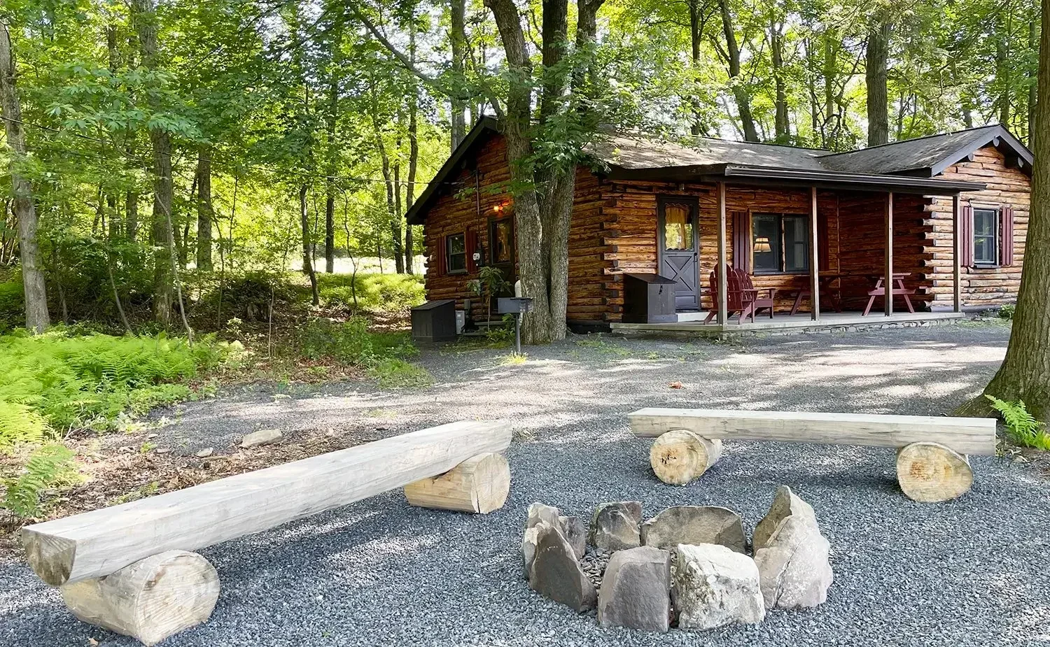 Wooded cabin with outdoor fire pit at Mountain Springs Lake Resort