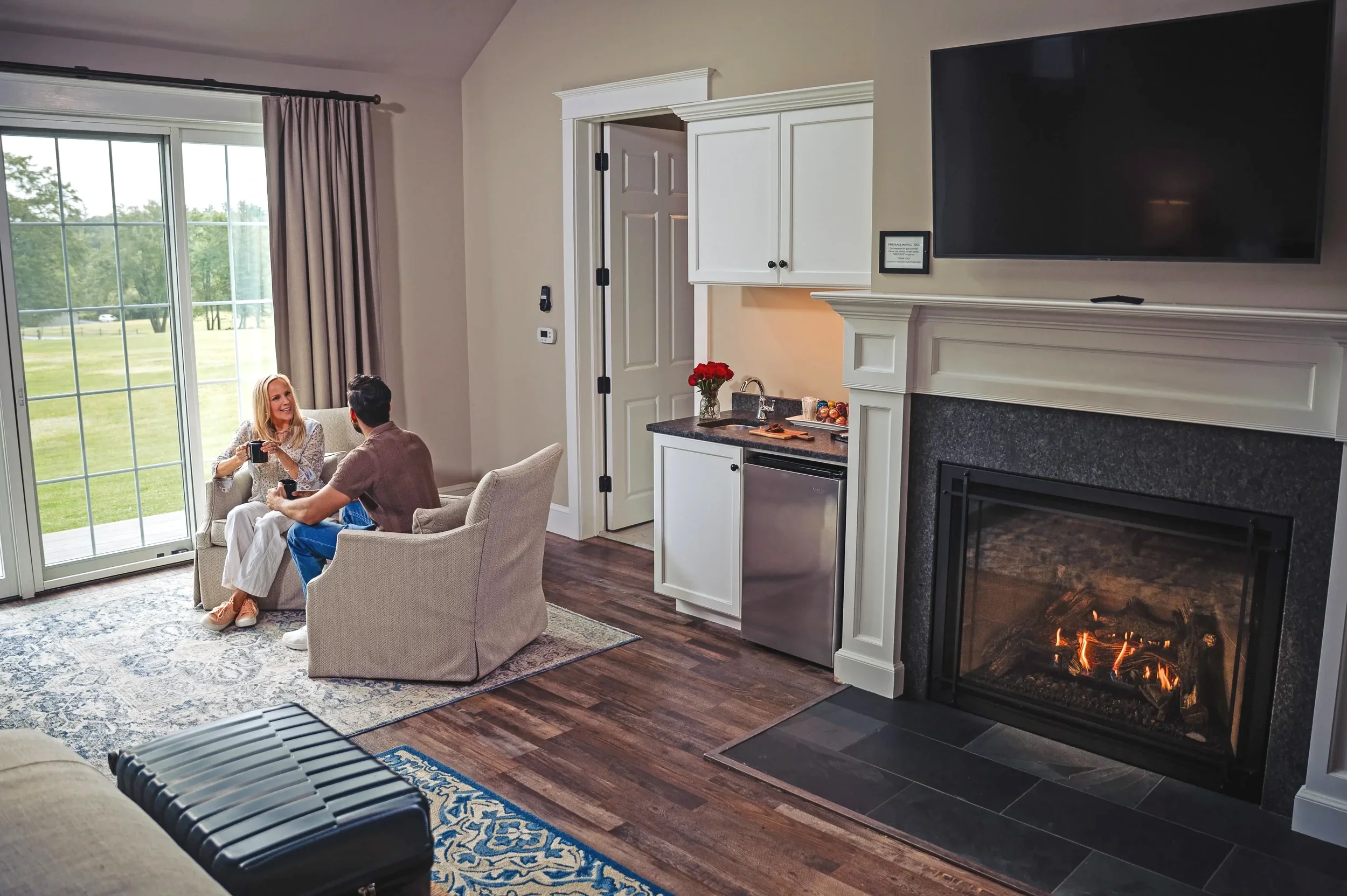 Couple relaxing in a luxury suite with fireplace at Mountain Springs Lake Resort