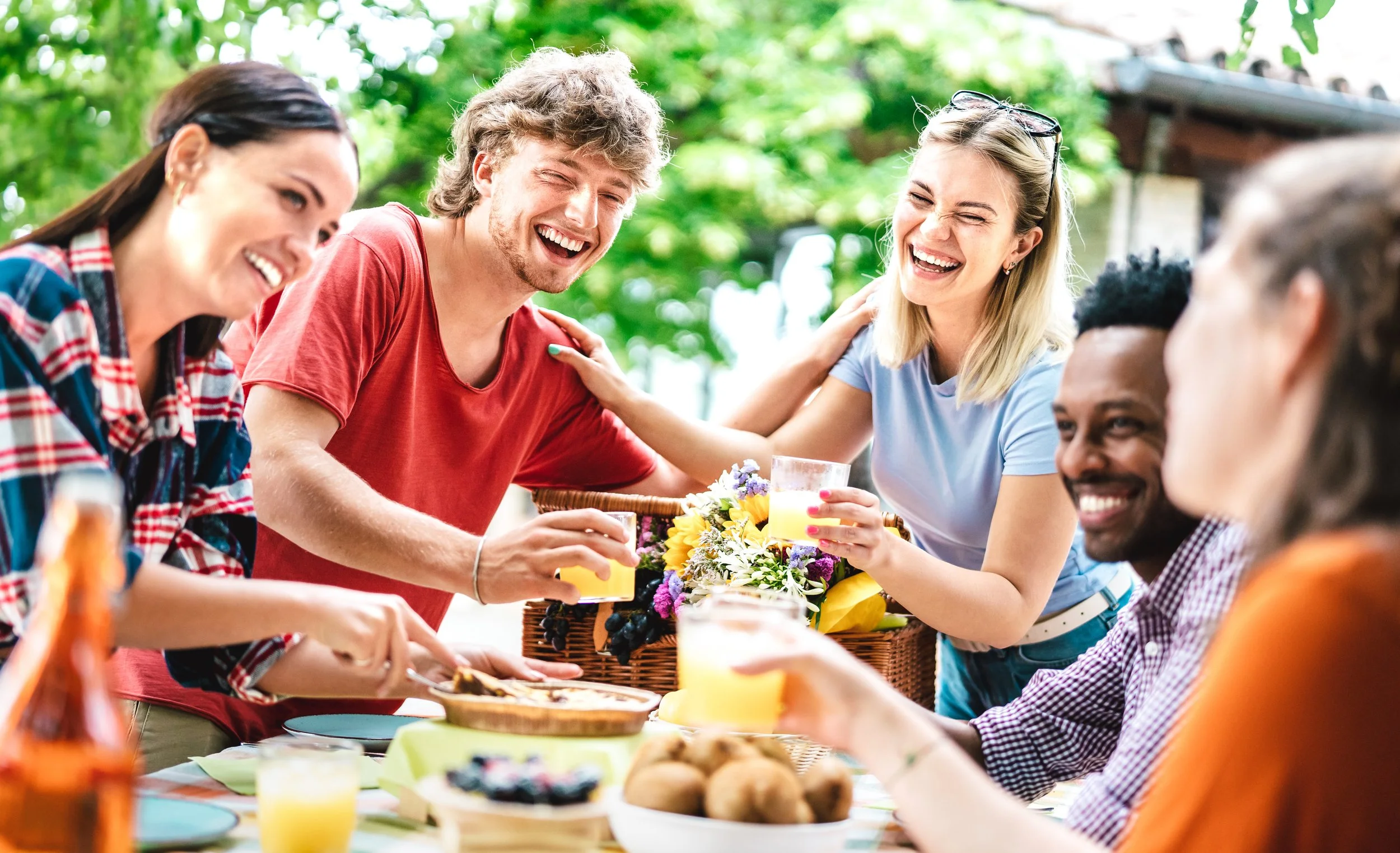 Couples gathering around outside table in springtime