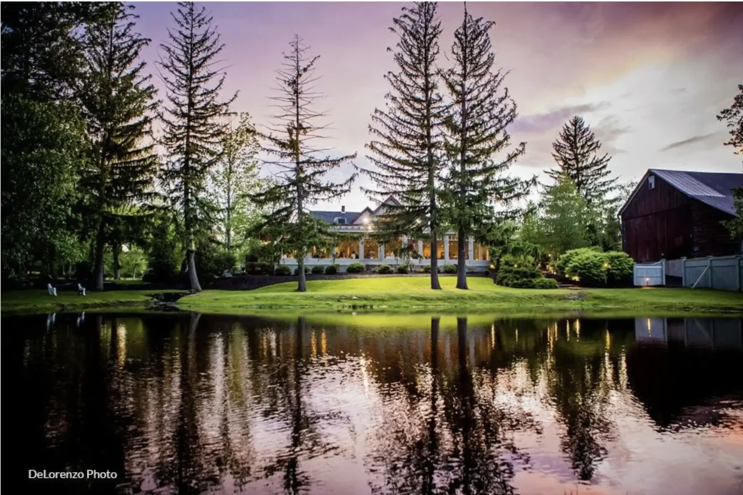 The Lodge at Mountain Springs Lake reflected on the water at sunset