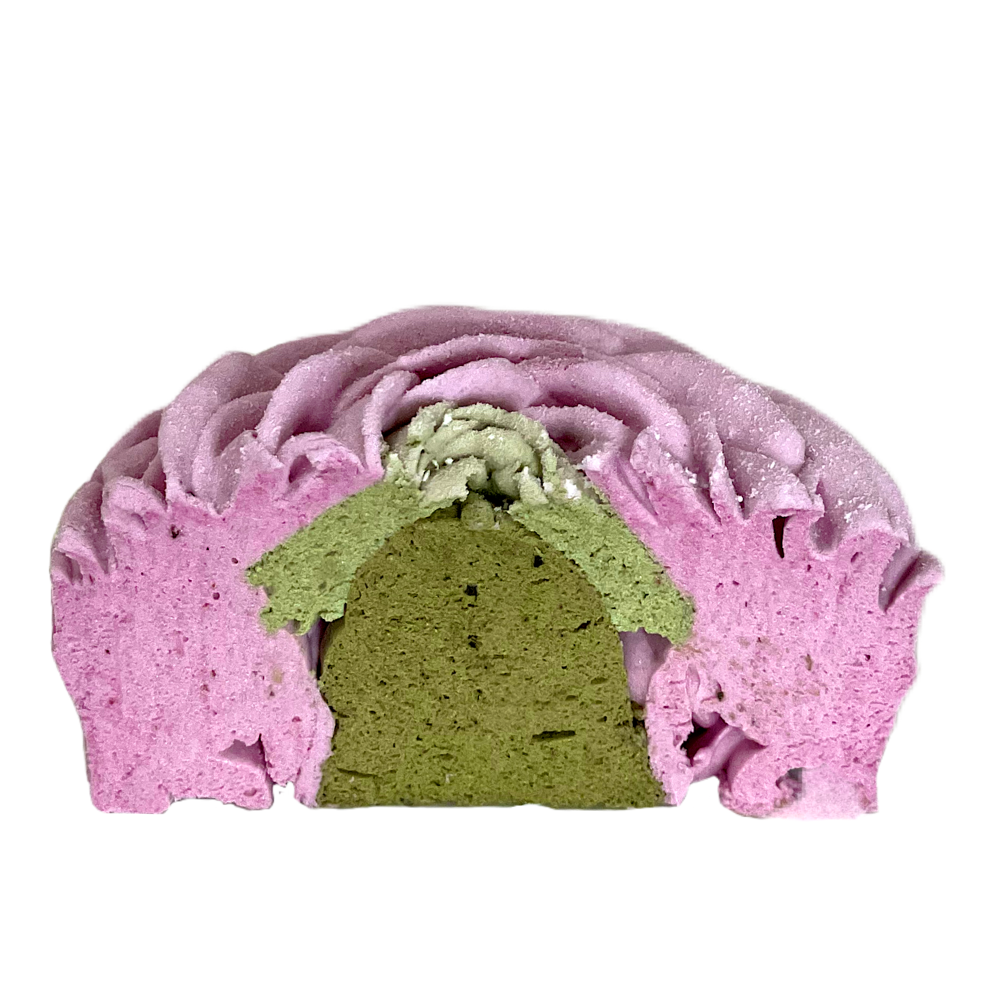 A halved green and pink dessert with a cream topping