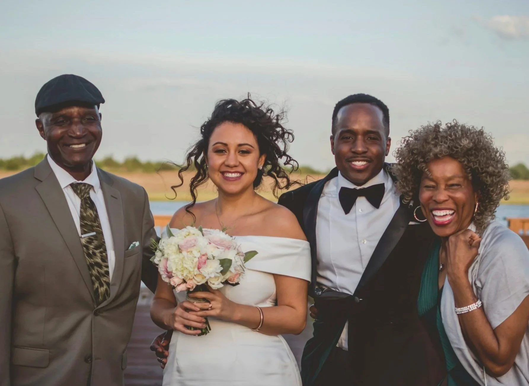 Couple surrounded by a set of parents, smiling