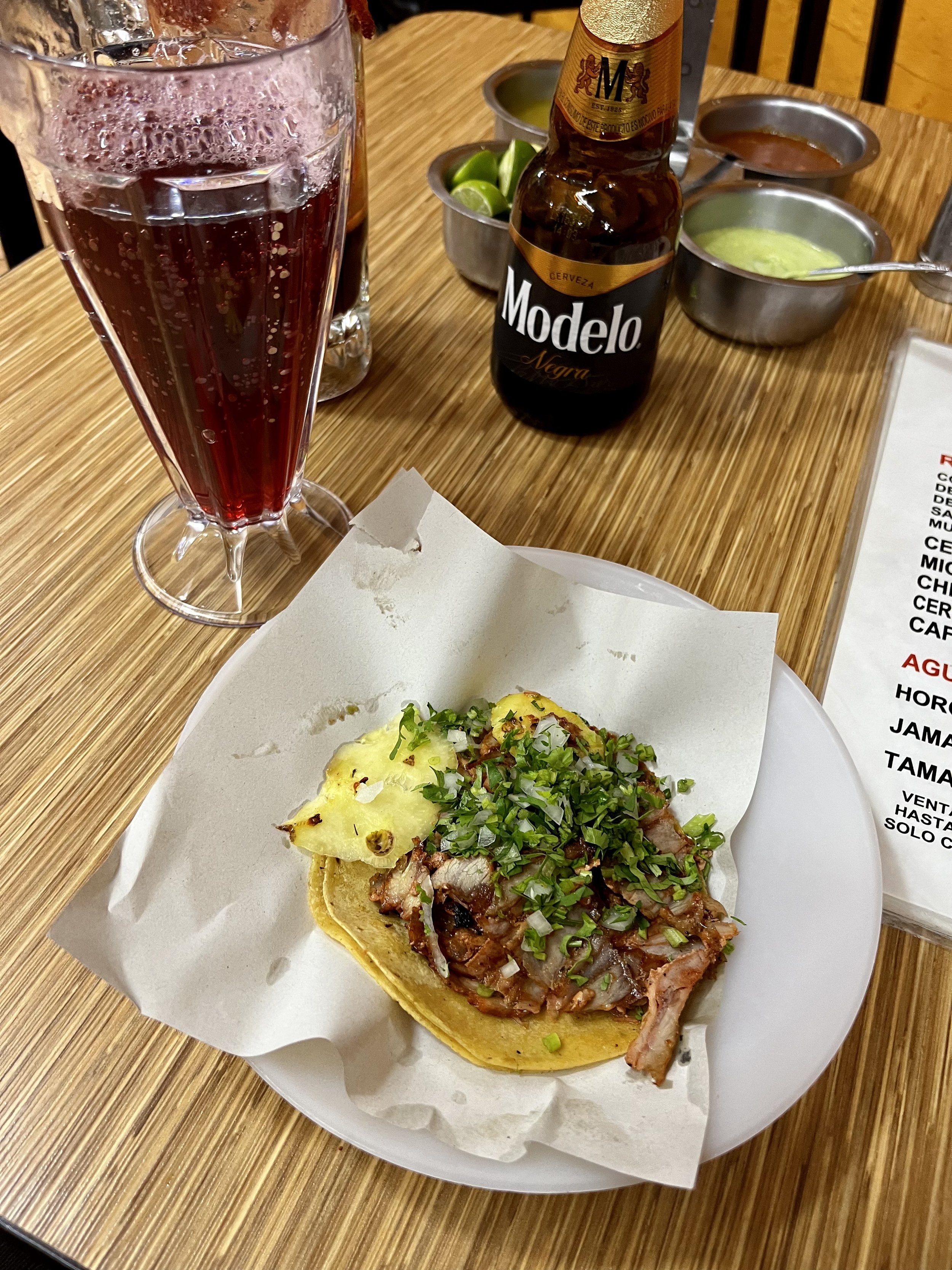 A tasty al pastor taco and Michelada at Tacos Los Cocuyos.