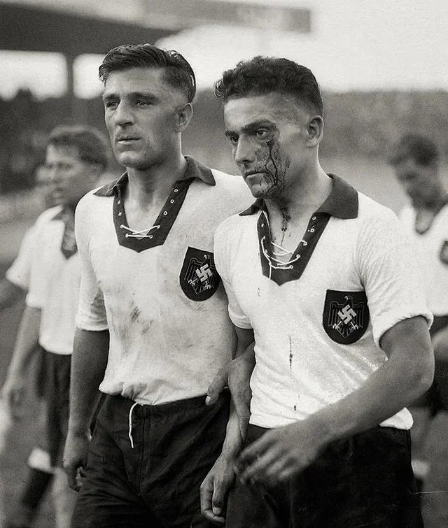 A bloodied German footballer leaves the pitch at Parc de Princes in the 1938 World Cup in France.