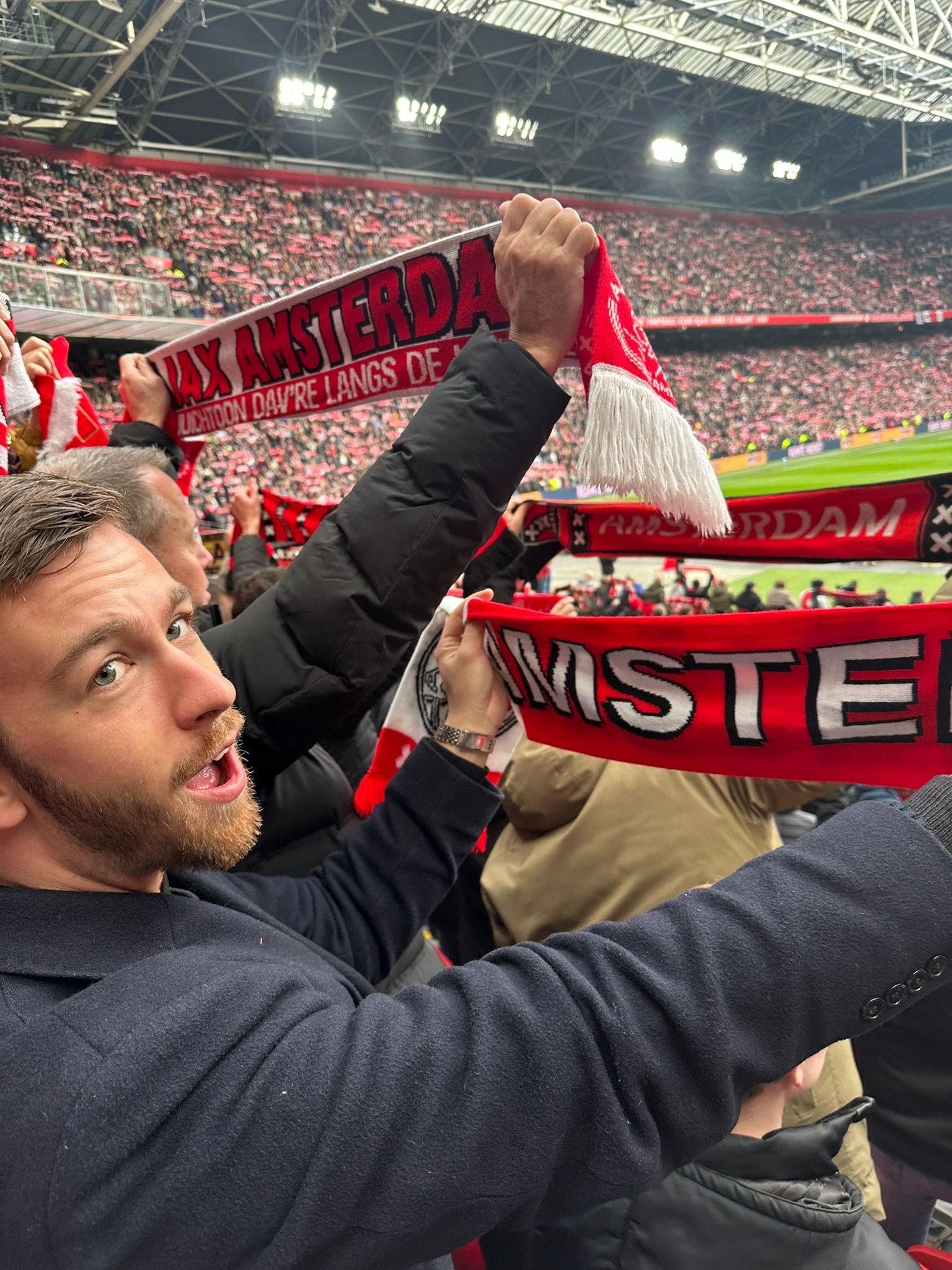 Ajax FC scarf in hand as a real fan.