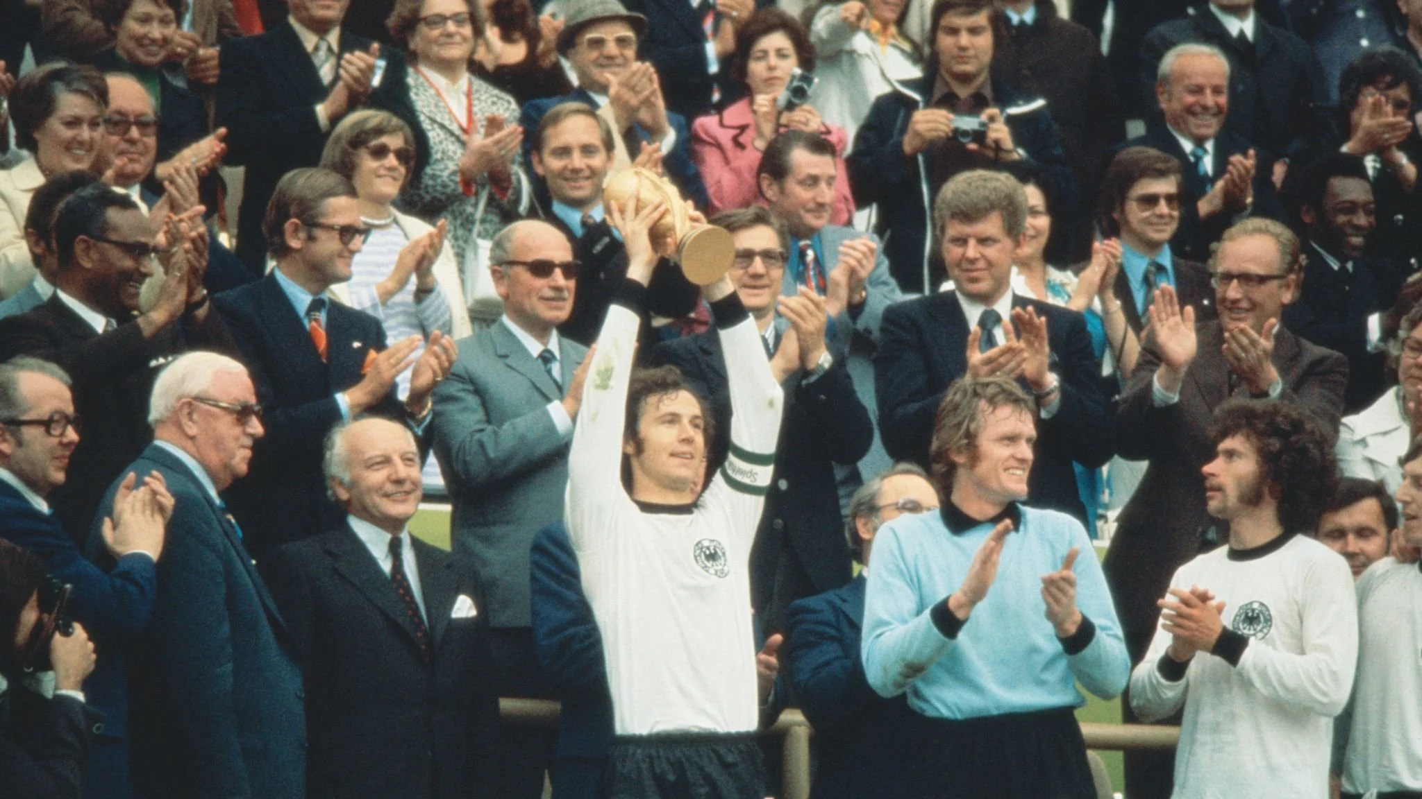 West Germany captain Franz Beckenbauer proudly lifts the trophy on home turf in the 1974 World Cup.