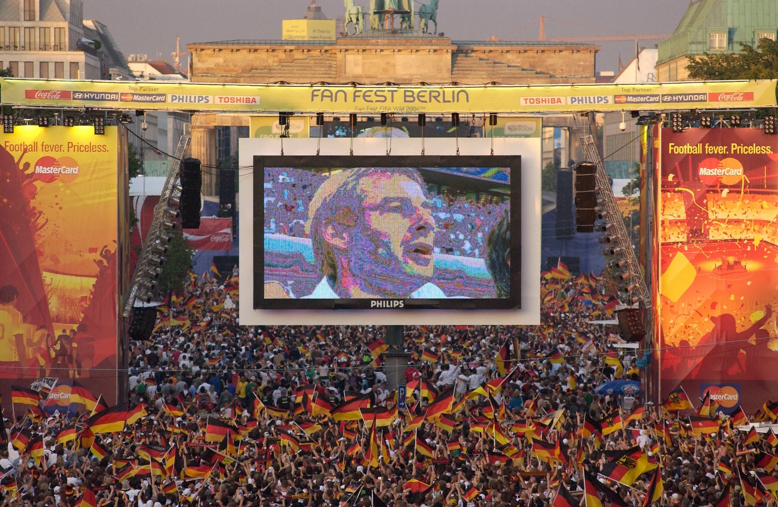 German fans outside the Brandenburg Gate proudly sing along to their national anthem at the 2006 World Cup in Germany.