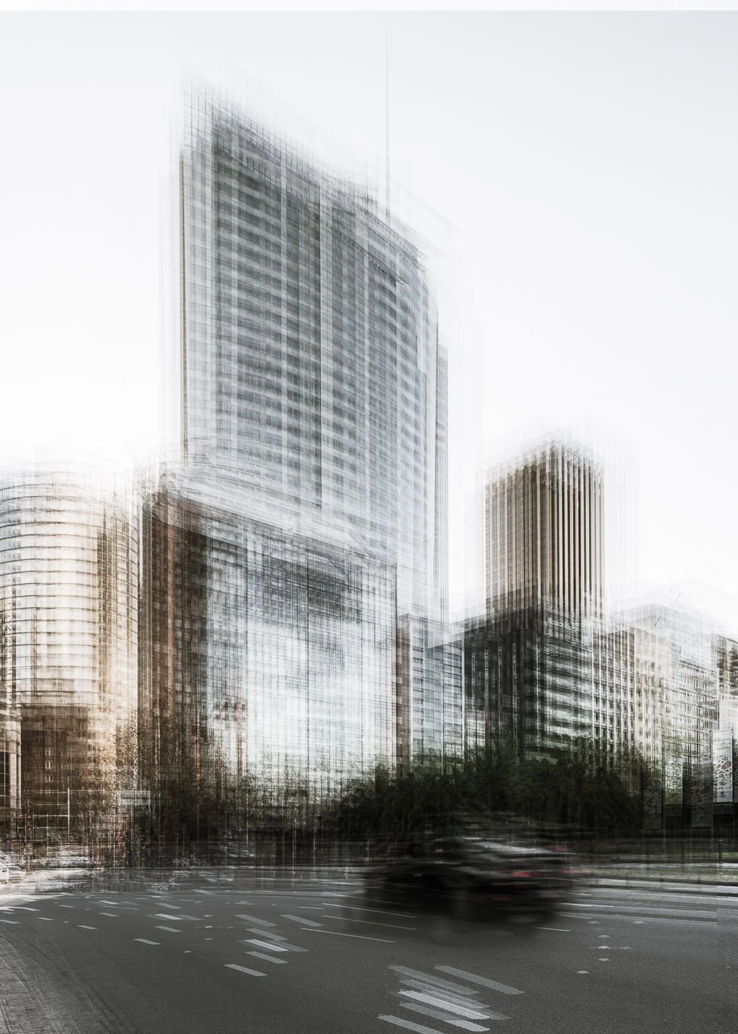 Blurred cityscape with tall modern skyscrapers and moving vehicles on the road.