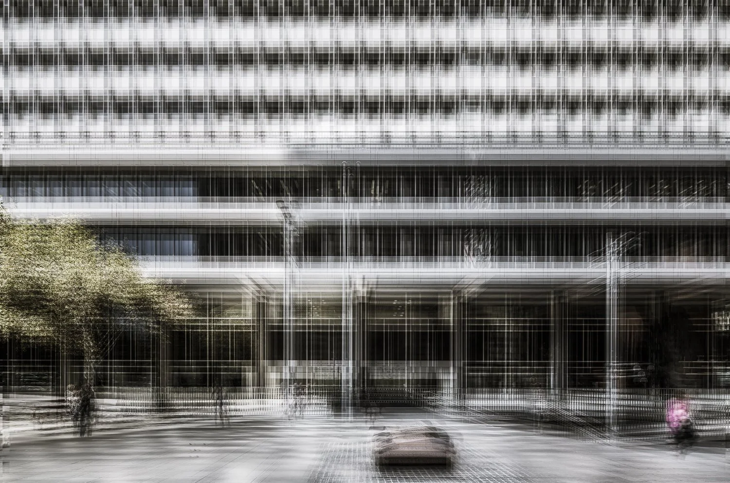 Blurred urban street scene with a modern building, pedestrians, a car, and trees.