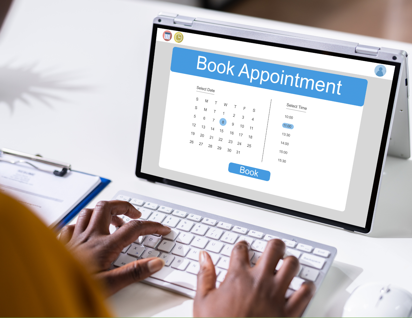 Person booking an appointment online on a tablet with keyboard, calendar and time selection visible.