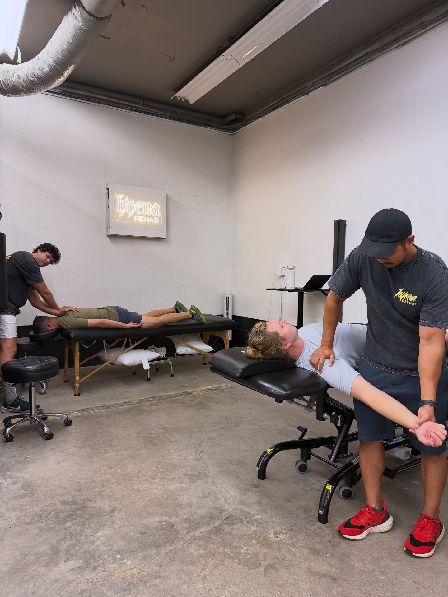 Physical therapist assessing shoulder mobility in Pacific Beach clinic