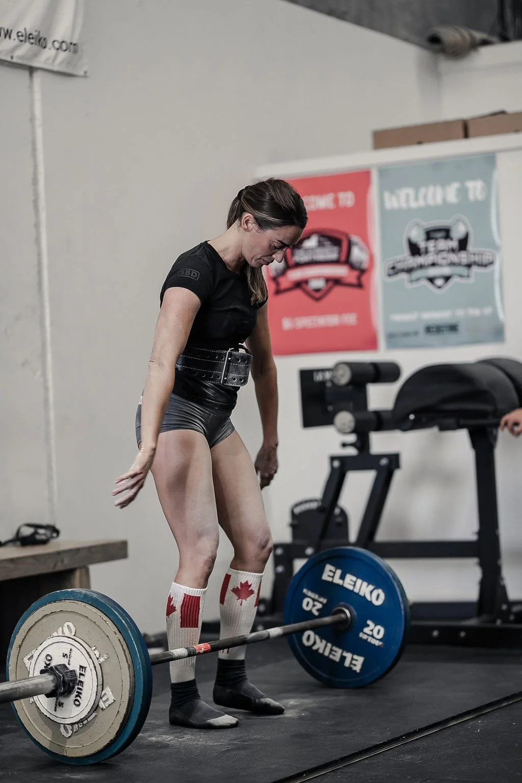Female member preparing to deadlift