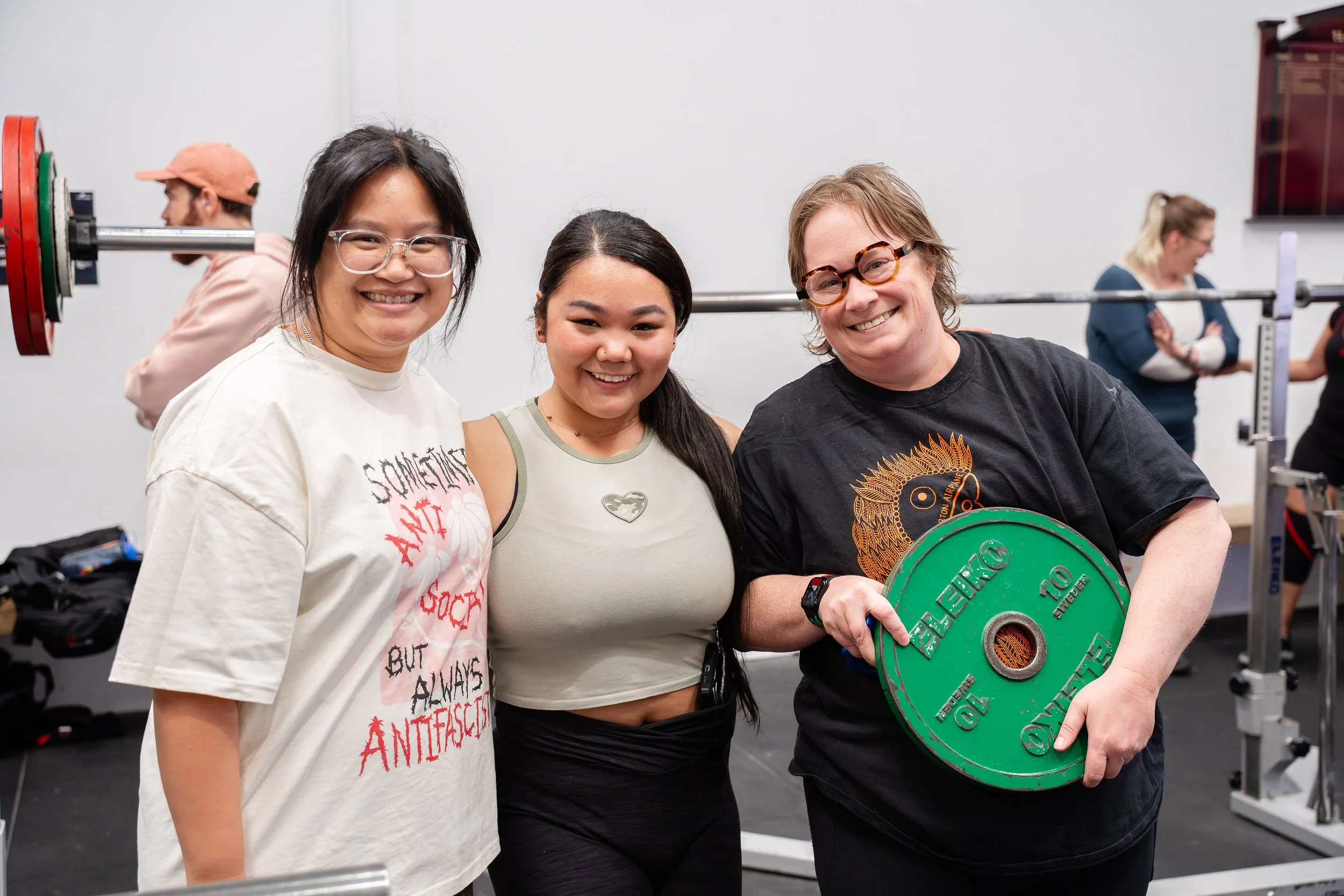 Three female members smile for the camera