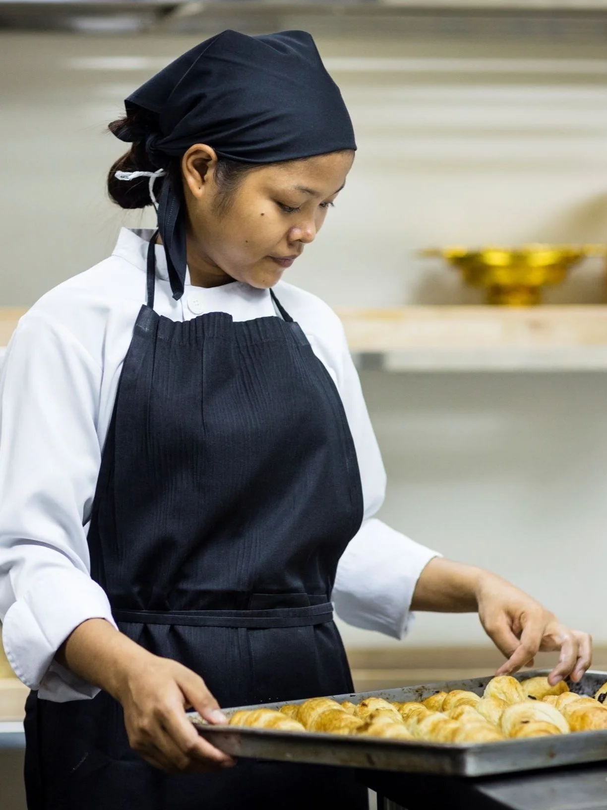 Pastry student making croissant