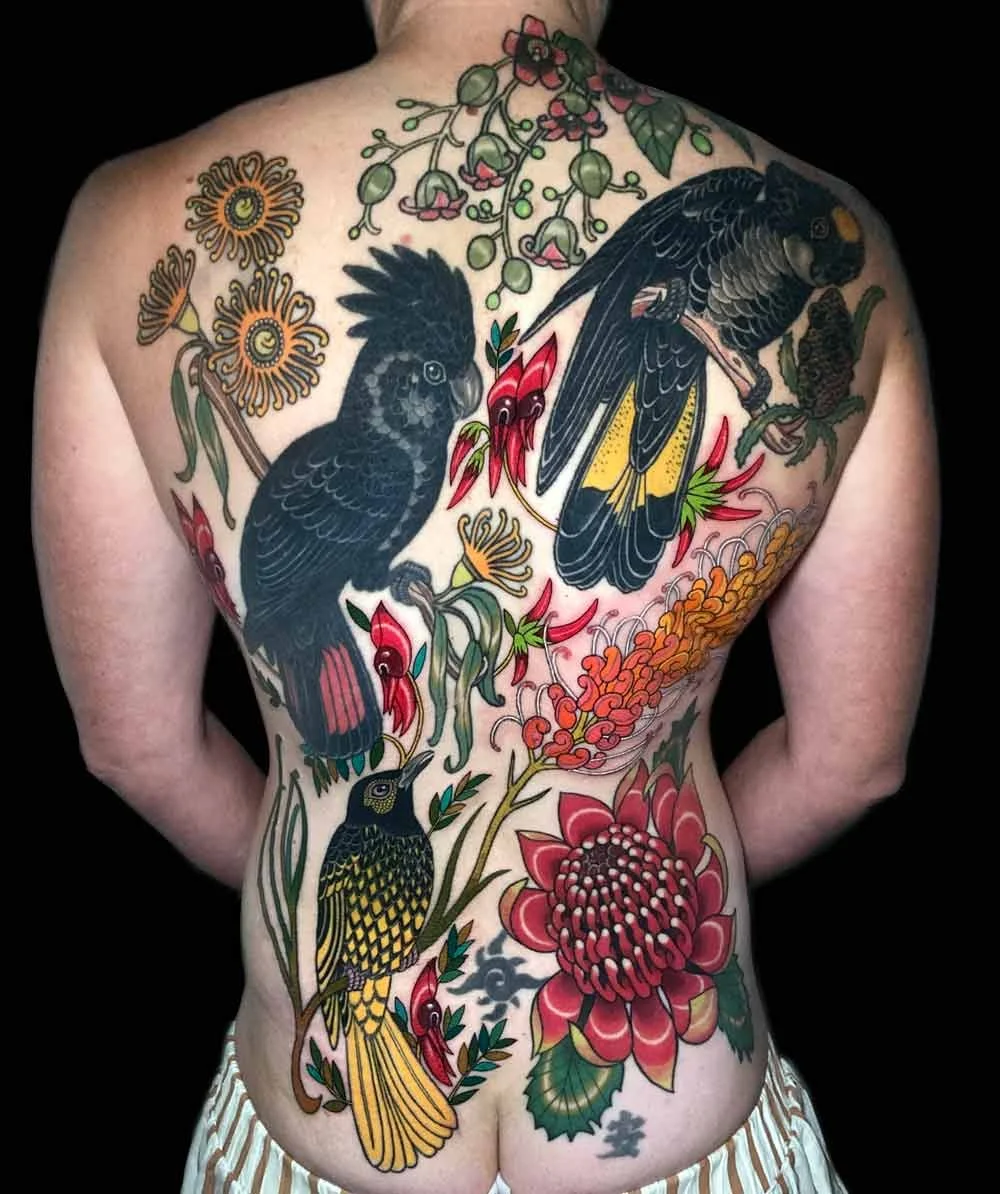 australian native birds and flowers in neo traditional realistic style back piece tattoo on a woman's full back tattoo 