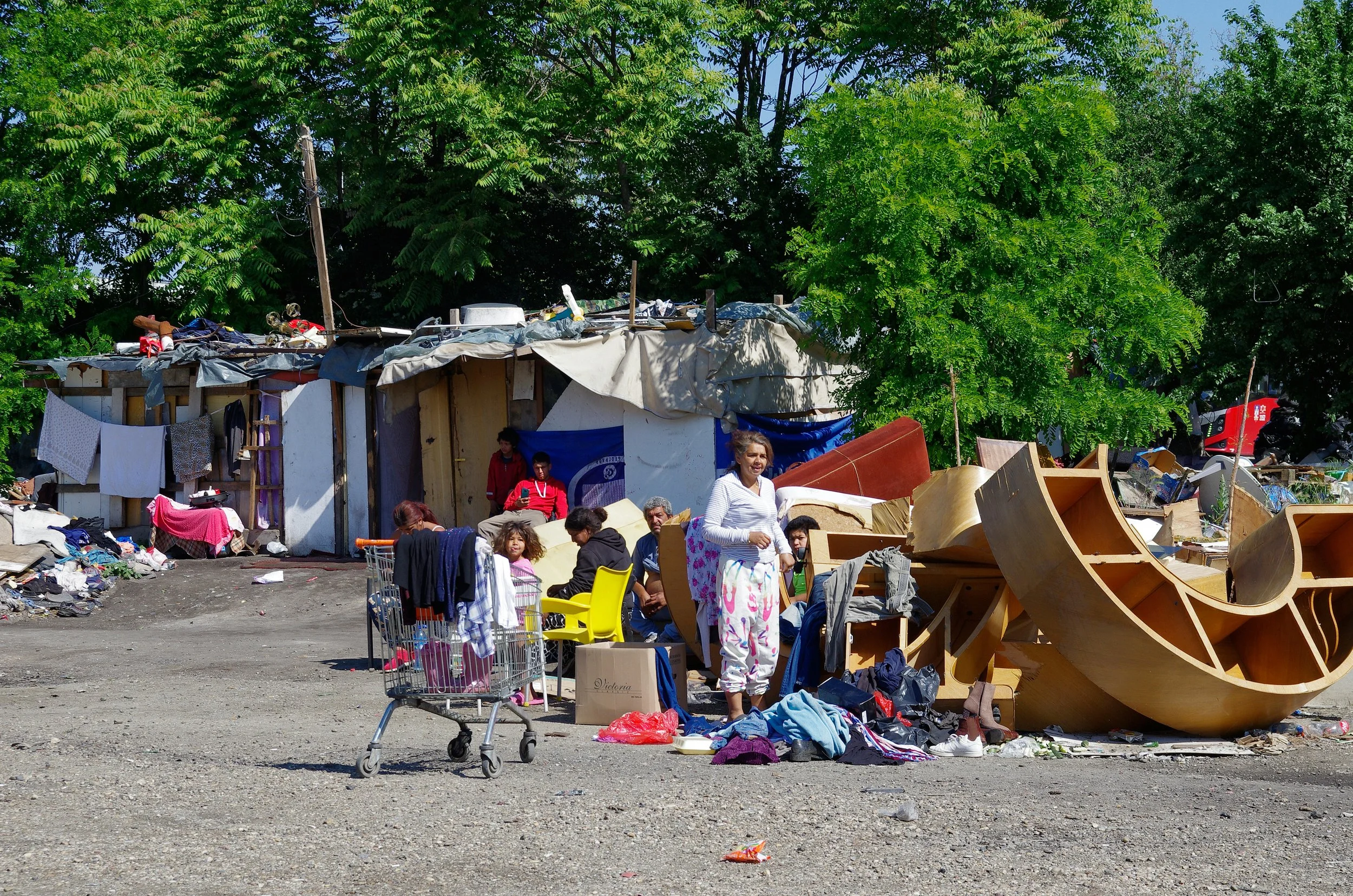 Makeshift homes with scattered belongings and debris