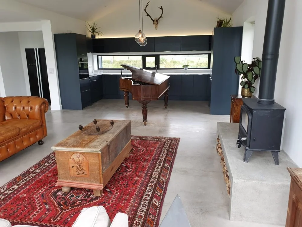 A completed Cork kitchen with an antique grand piano centrepiece