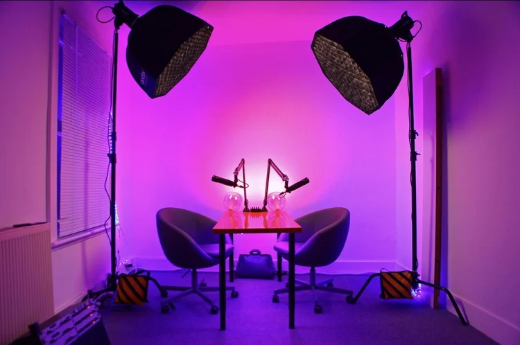 The original Podcast Studio Hire recording setup with microphones and pink lighting in October 2019