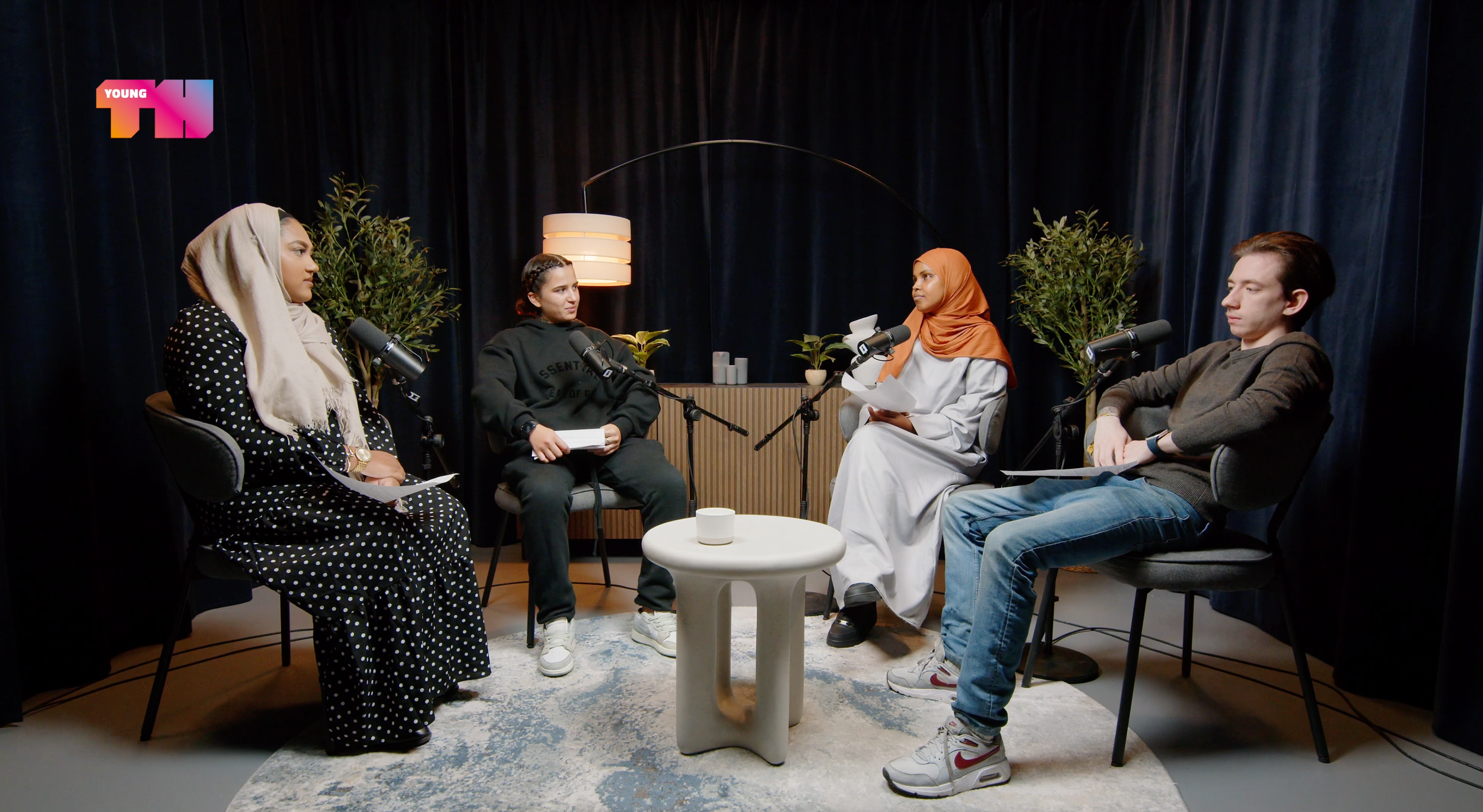 Four-person podcast recording on our Armchair Set at our London podcast studio, with professional microphones for each guest.