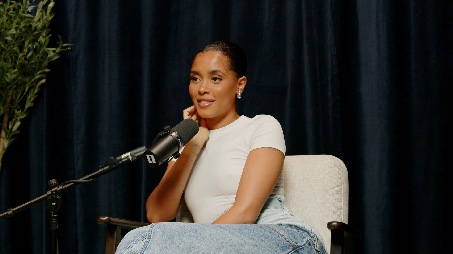 Woman being interviewed at Podcast Studio Hire in London using a professional studio microphone.