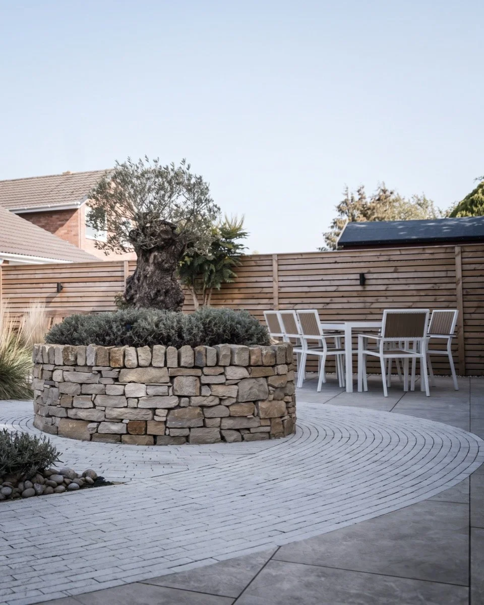 Modern garden design with curved paving detail, structured planting and bespoke raised beds.