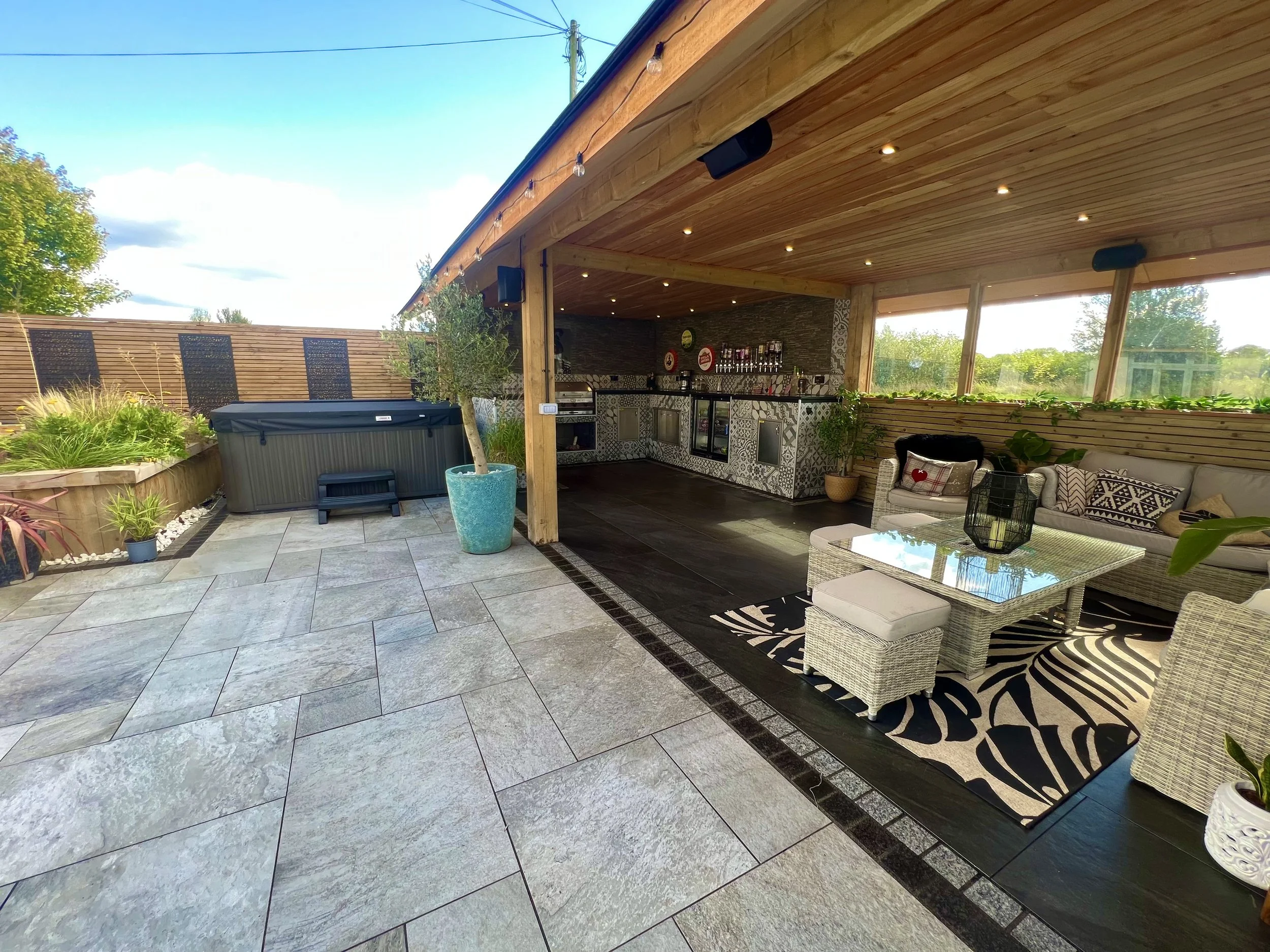 Wooden structure garden BBQ shelter in eccleshall with fencing