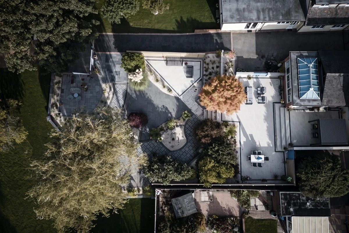 Aerial view of premium garden landscaping featuring curved pathways, patios and decorative planting.