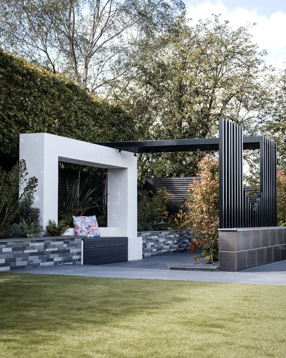 High-end garden landscaping with modern patio areas, architectural details and elegant planting.