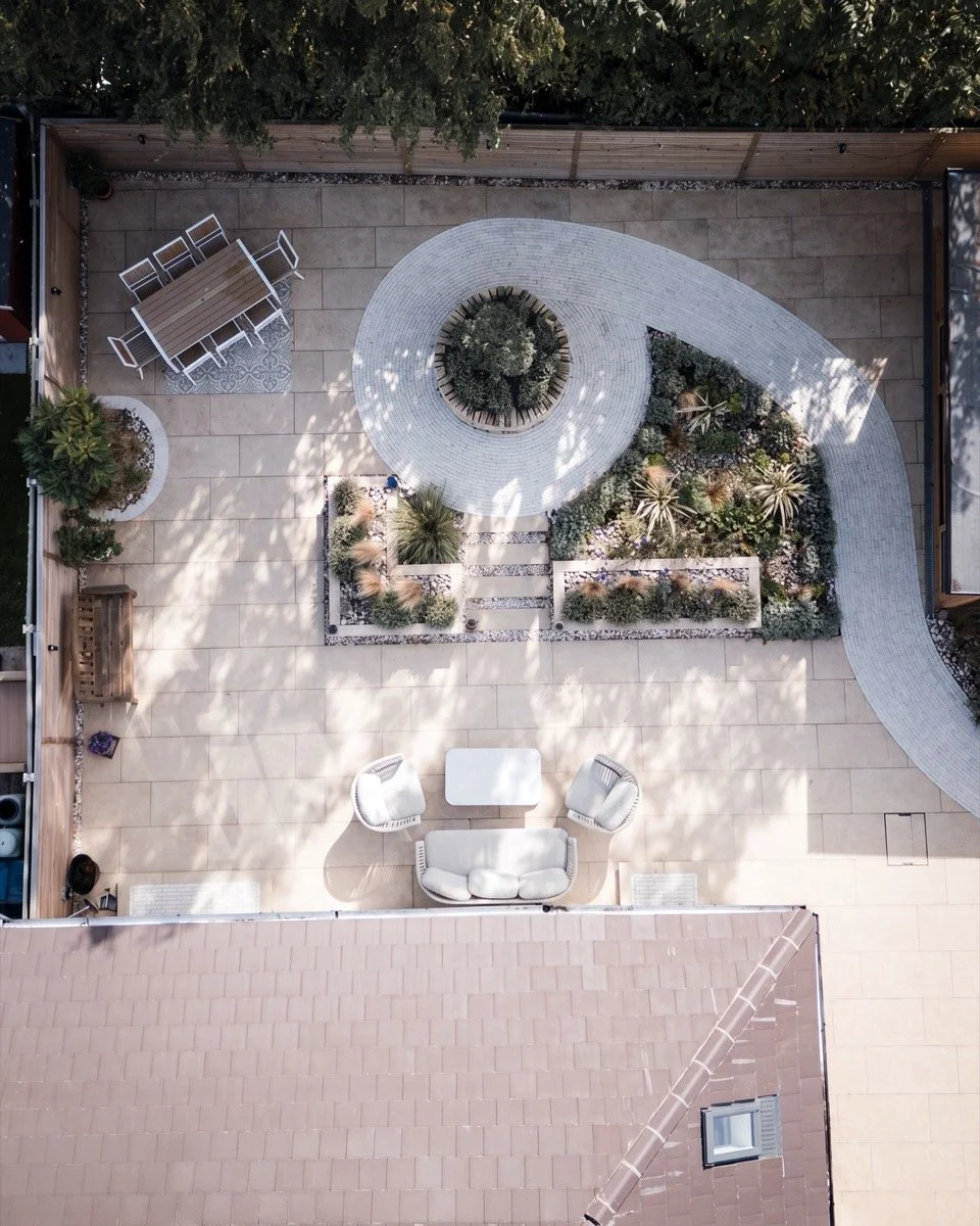 Beautifully landscaped patio and dining area with contemporary fencing and feature planting.