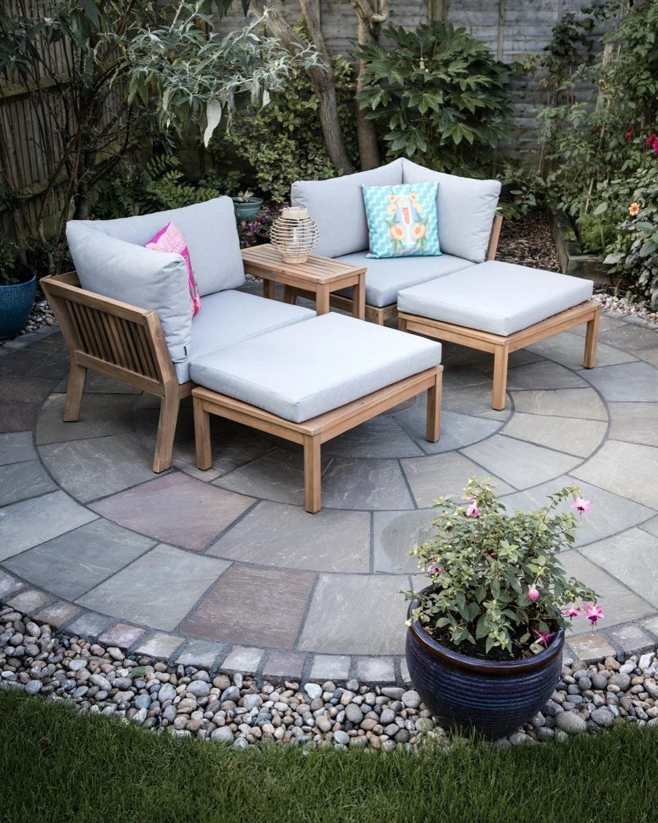 Circular garden patio featuring decorative block edging and natural stone paving.