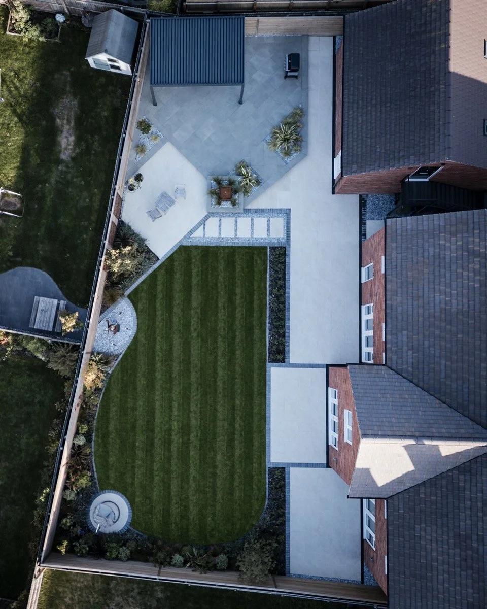 Modern garden landscaping with decorative stepping stones, gravel pathways and neatly finished lawn edges.