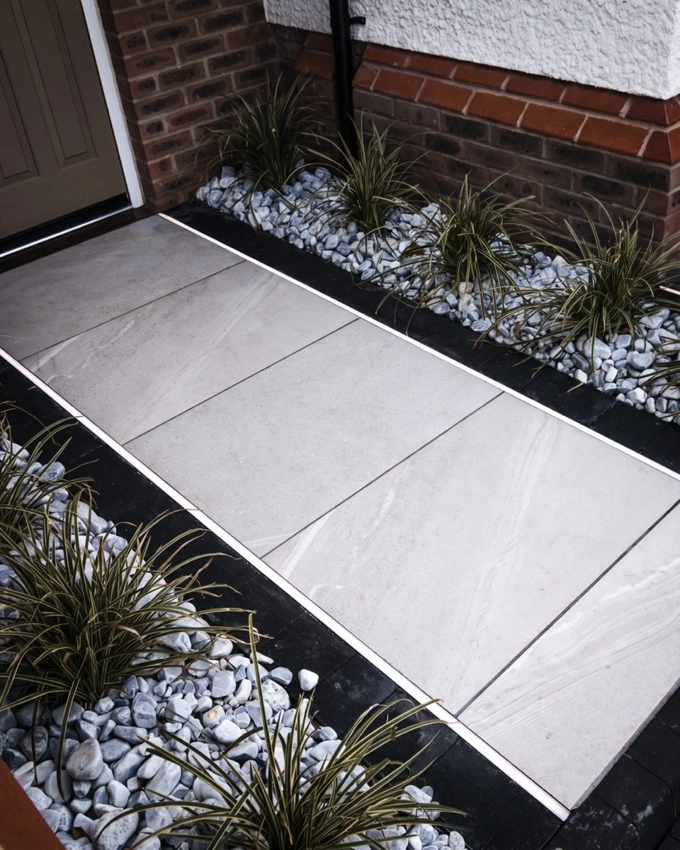 Contemporary outdoor living space with modern pergola, timber fencing and carefully landscaped borders.