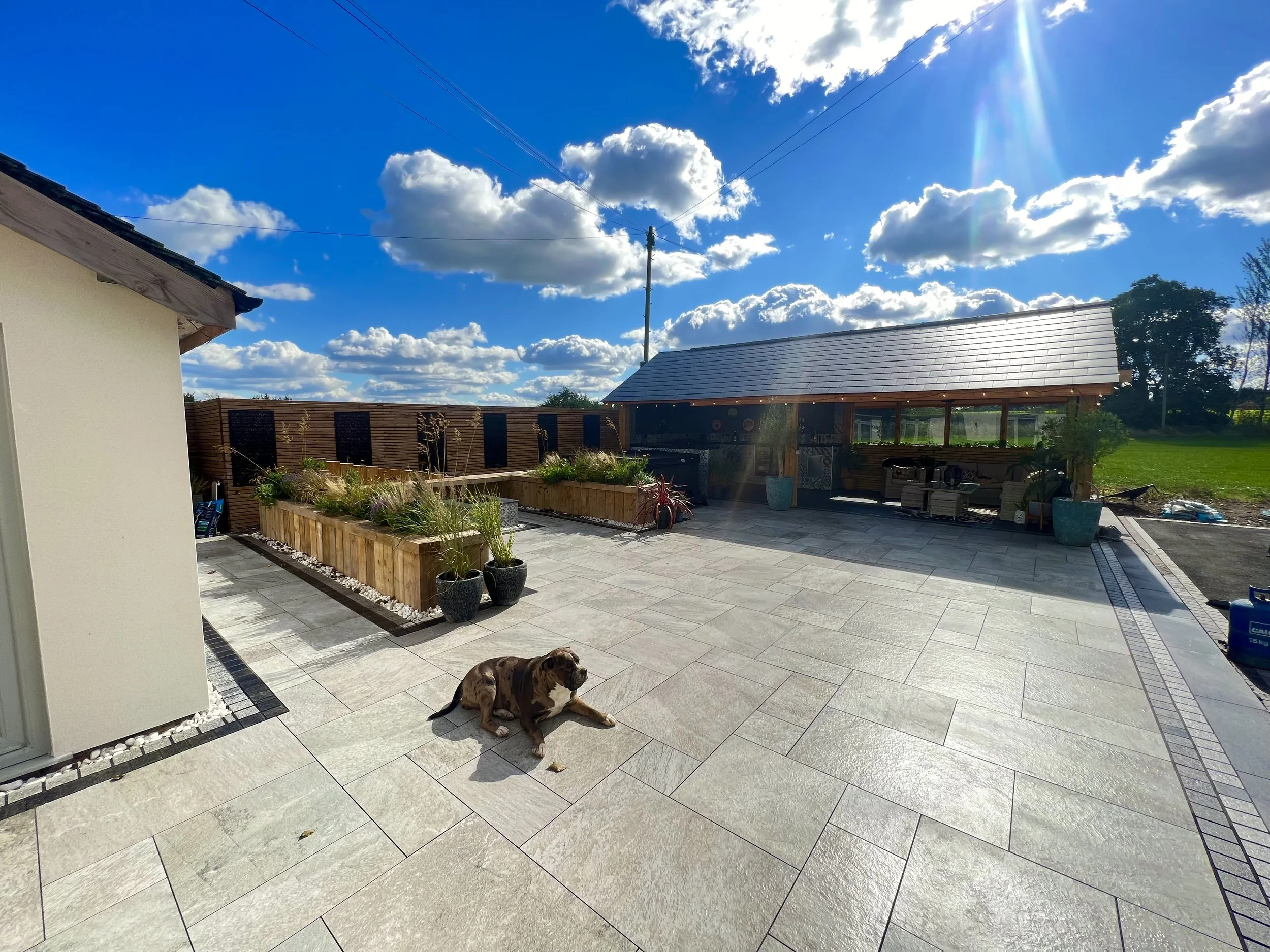 Patio area with new paving slabs and wooden gazebo made by tc fenciing and landscaping